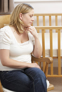 woman-in-room-with-empty-crib